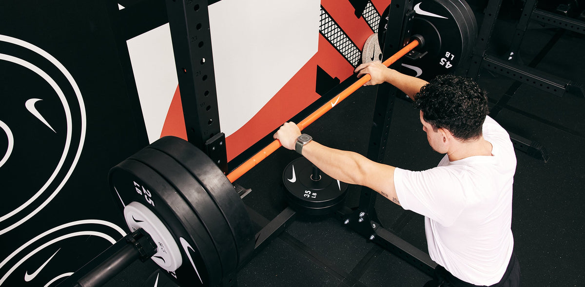 Male athlete preparing for a heavy lift at the Nike Squat Rack