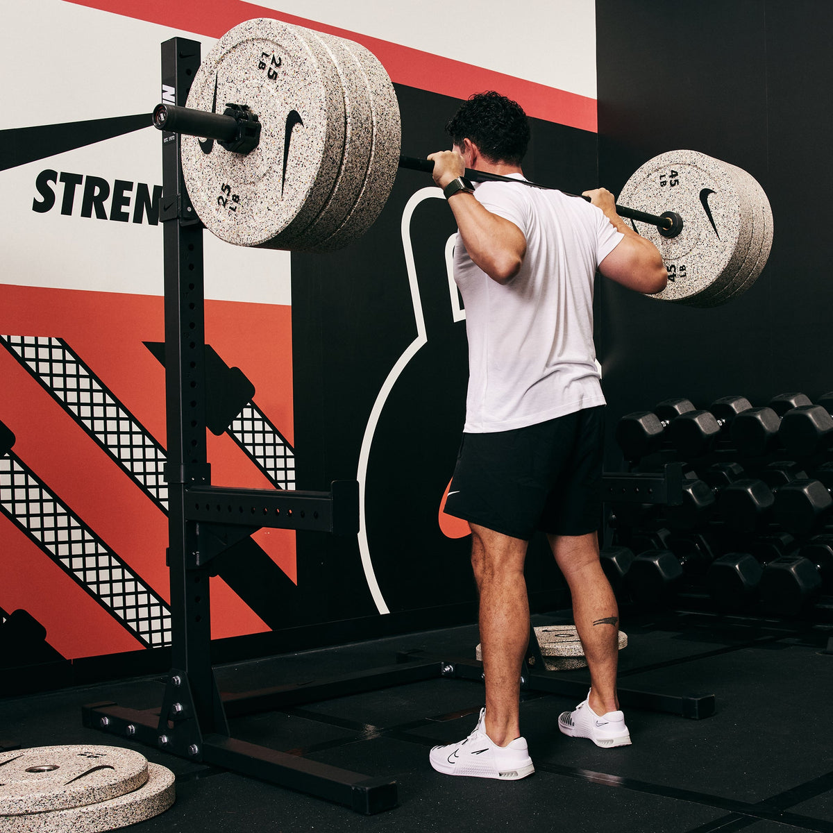 Male athlete squatting heavy with the Nike Squat Stand