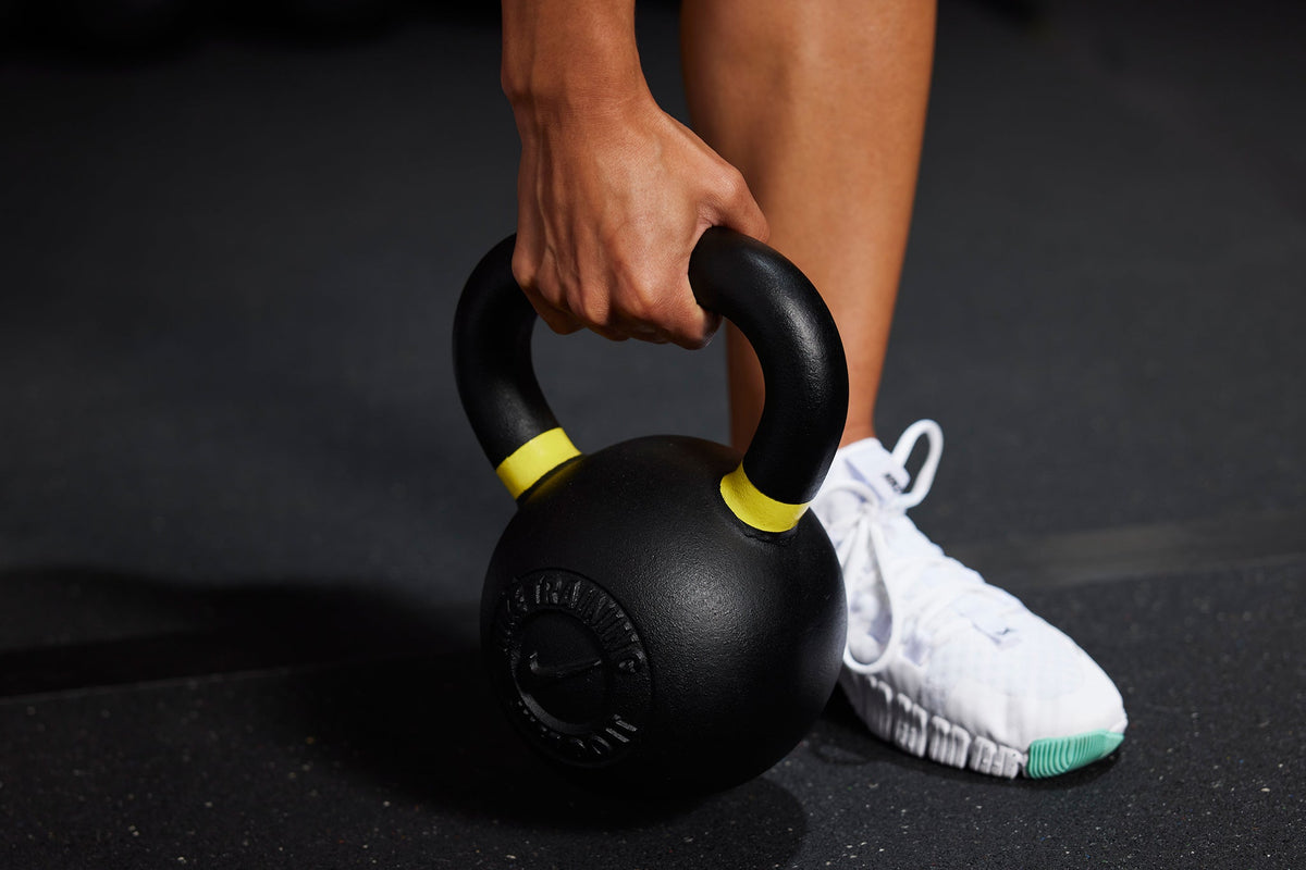 Athlete grabbing the handle for the Nike Kettlebell