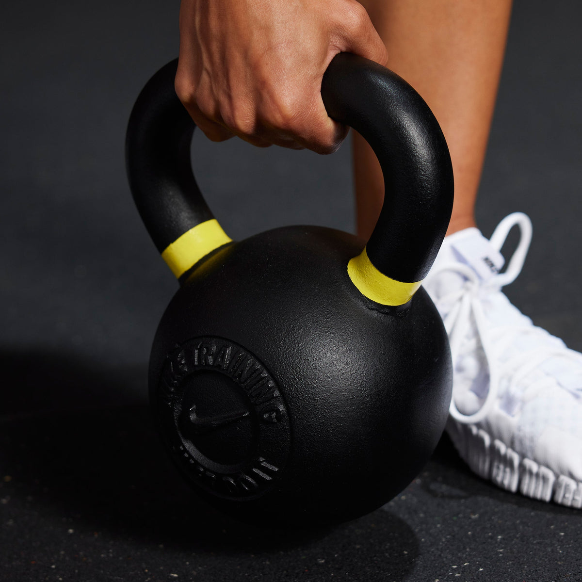 Athlete grabbing the handle for the Nike Kettlebell